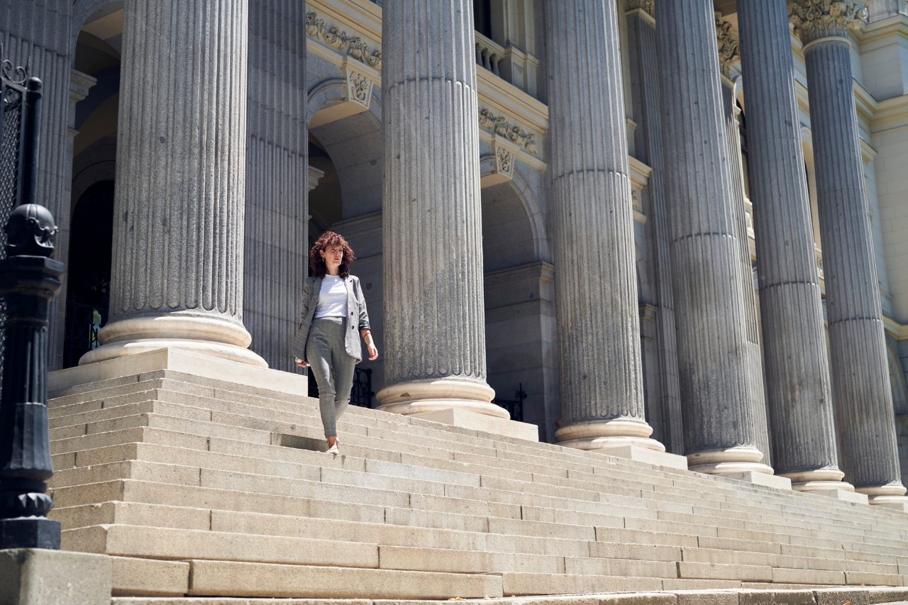 Woman on the stairs of the Madrid Stock Exchange
